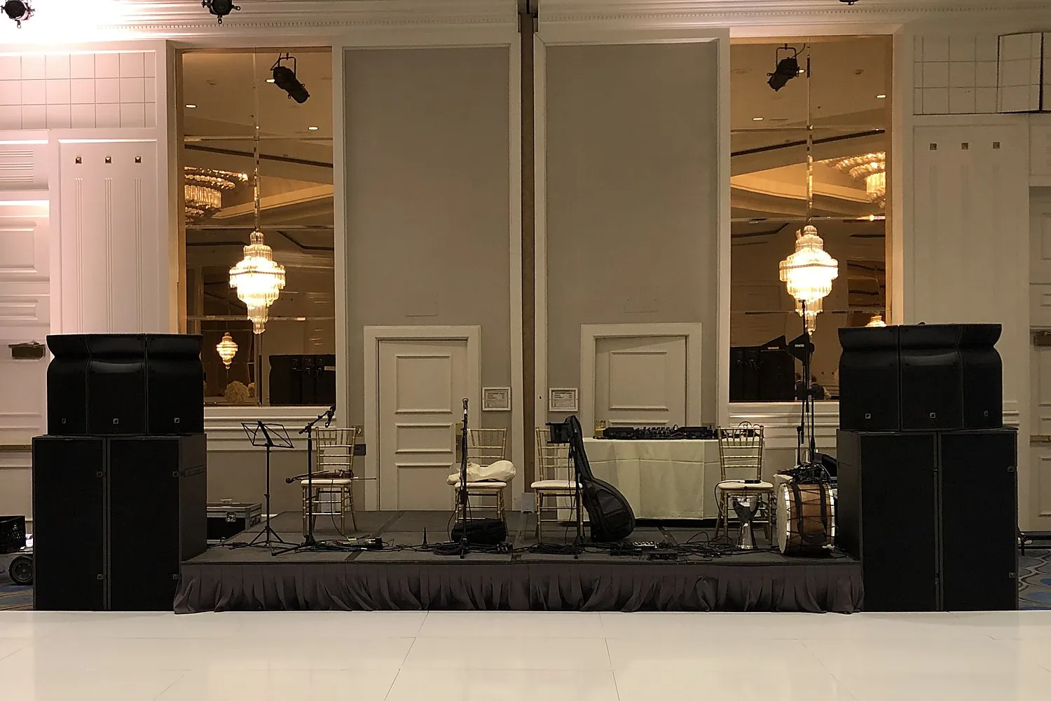 Wedding band stage and white dance floor with AVE line-array speakers