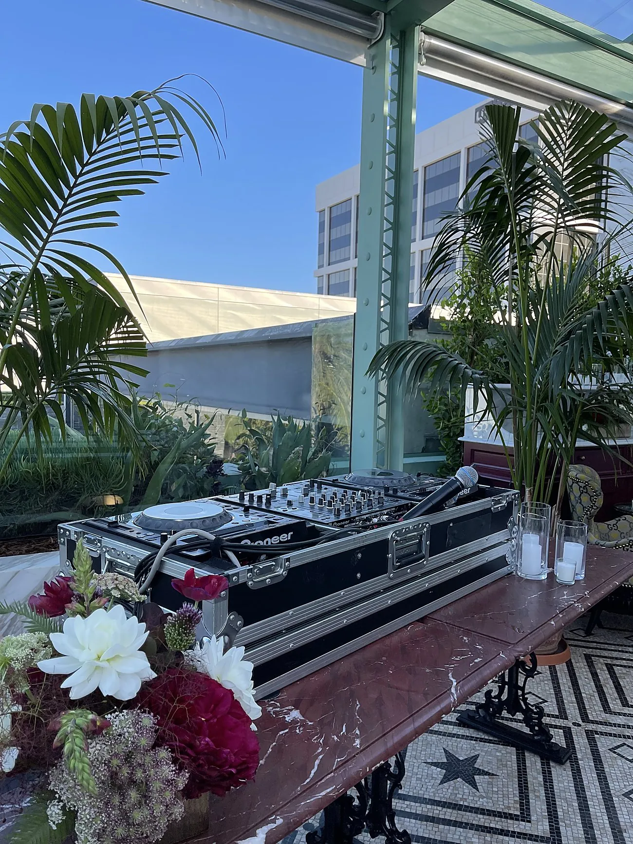 AVE DJ setup with florals on the Gucci Osteria rooftop terrace