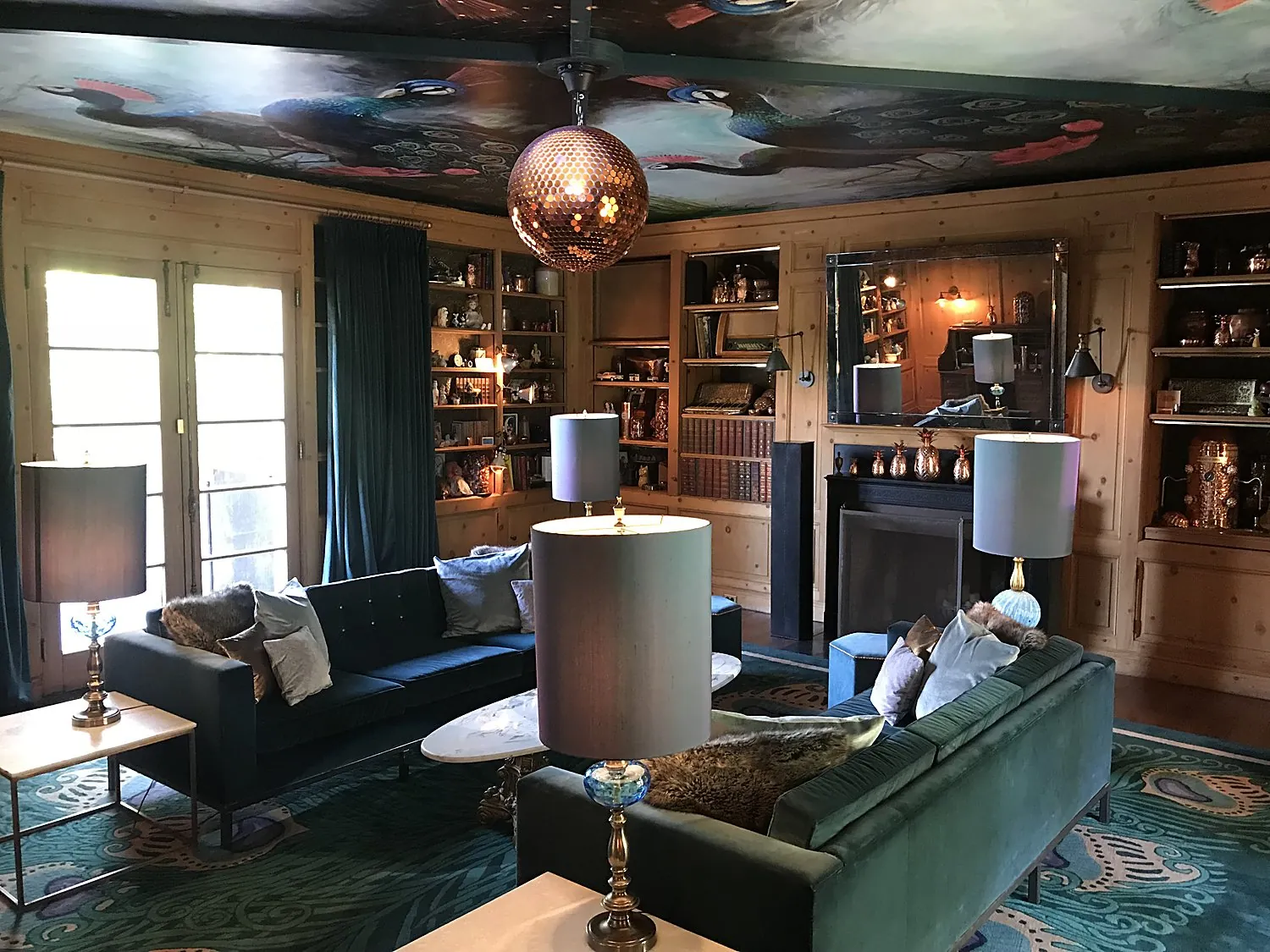 Peacock-painted library lounge with copper mirror ball at an Absolut Elyx event