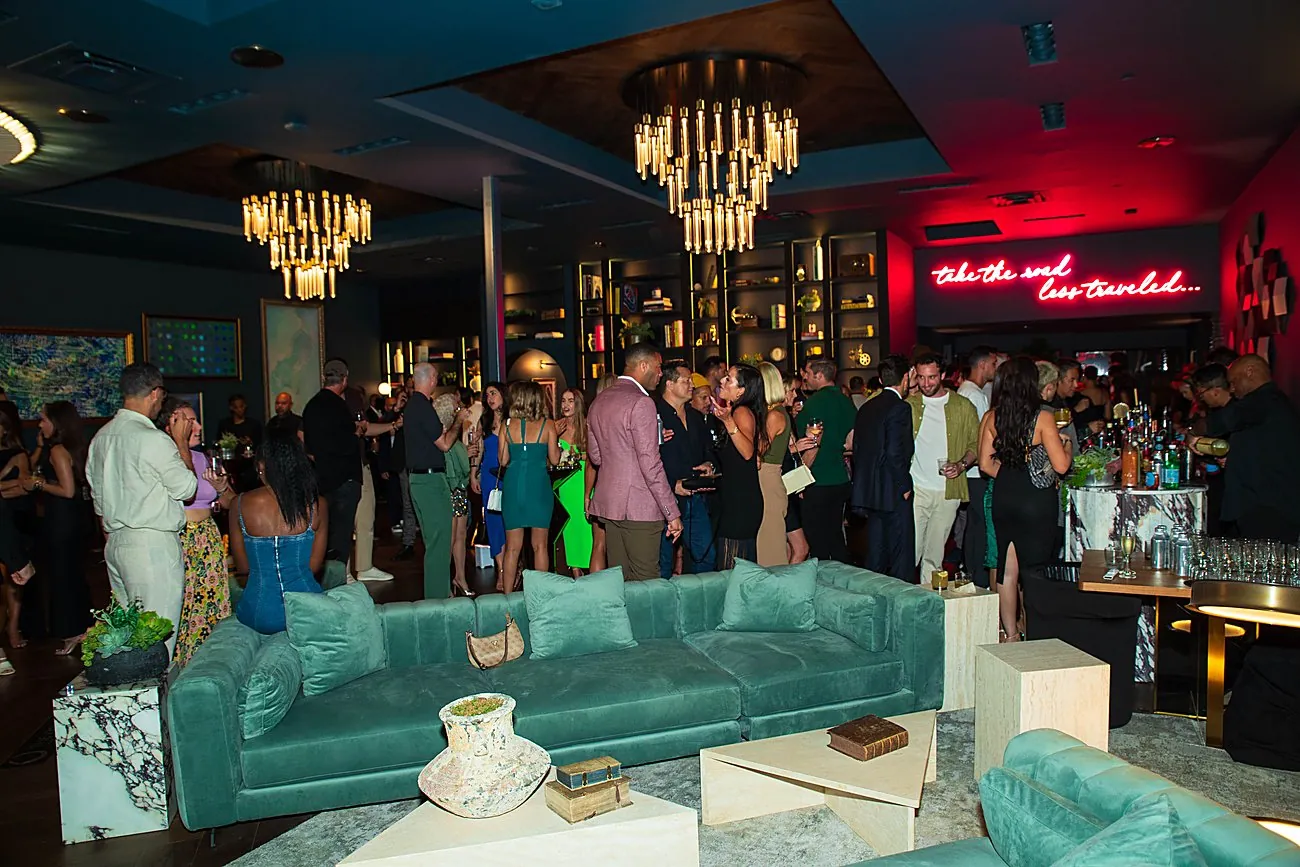 The event in full swing beneath the neon sign at an Oppenheim Group event