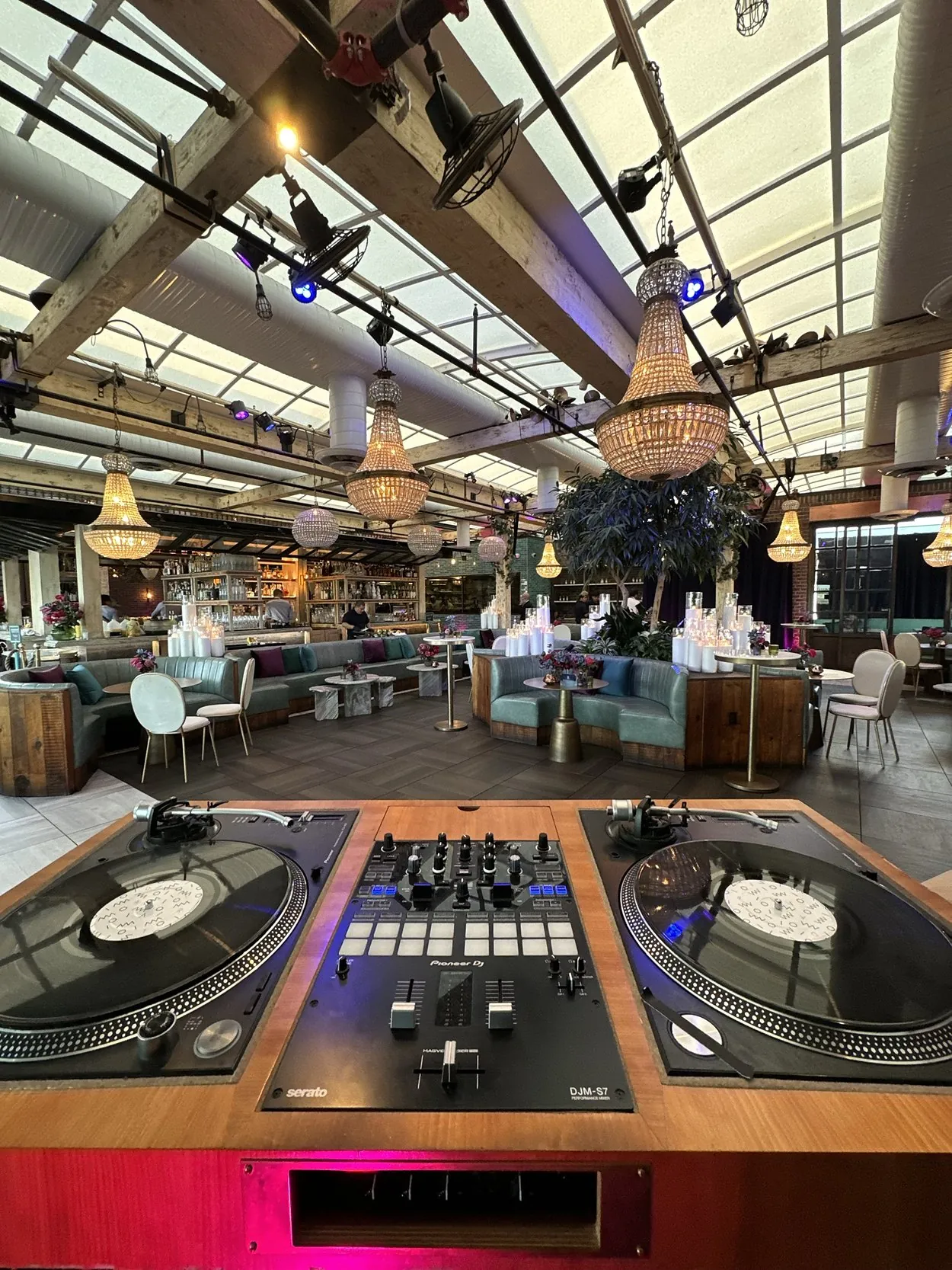 Rooftop turntables under string lights at Catch