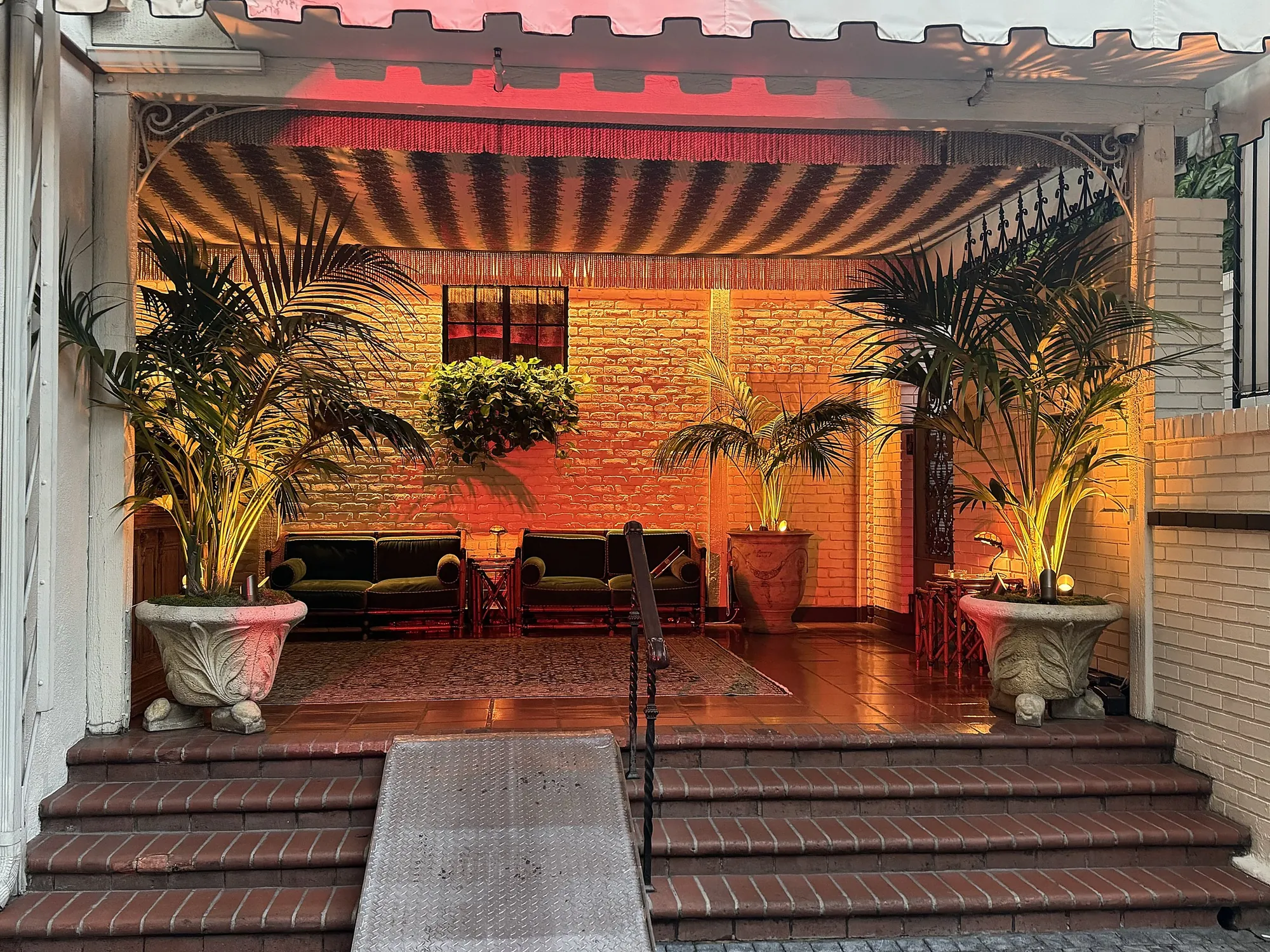 Red patterned lighting across an estate courtyard at night