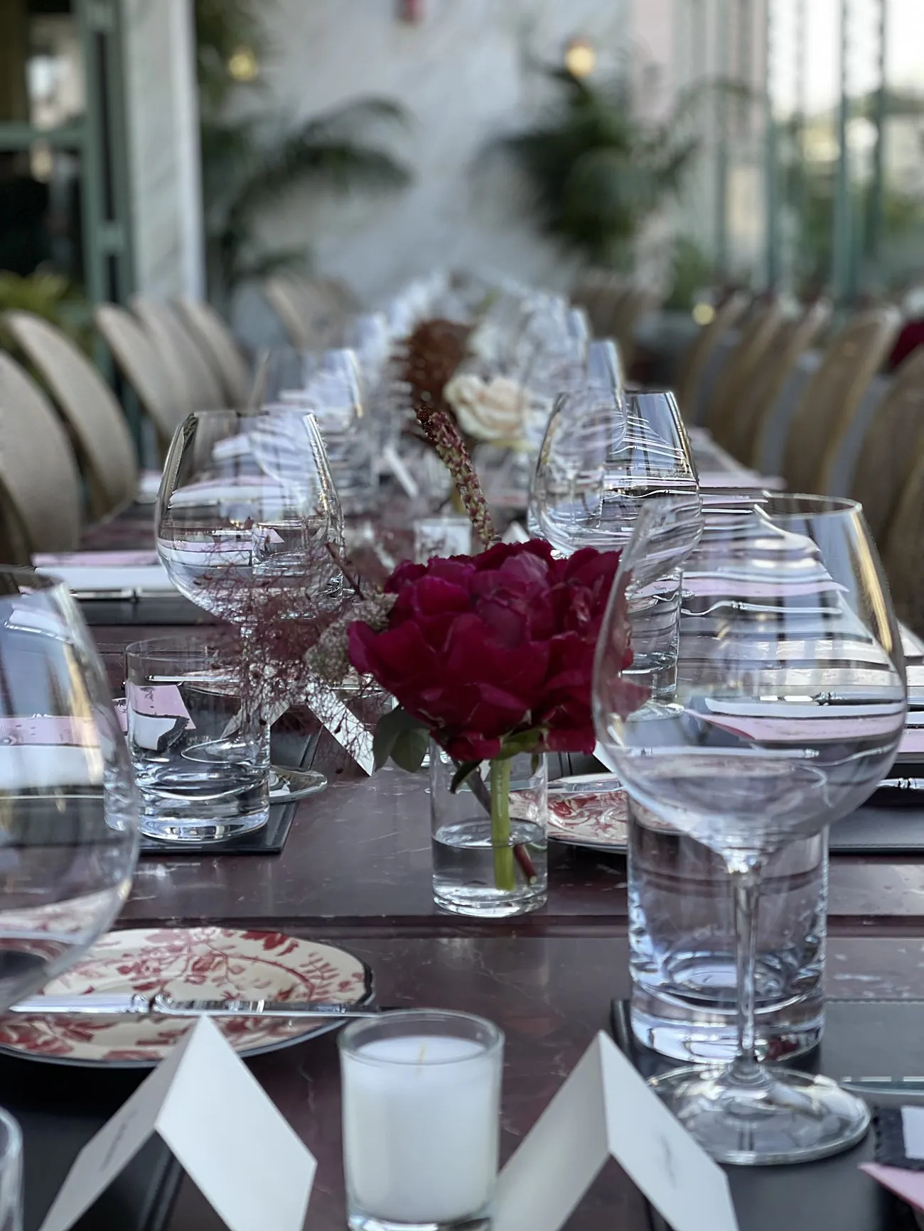 The birthday dinner table set on the Gucci Osteria rooftop, with florals and Gucci china